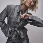 Fashion model with short blonde wavy wig in metallic outfit.
